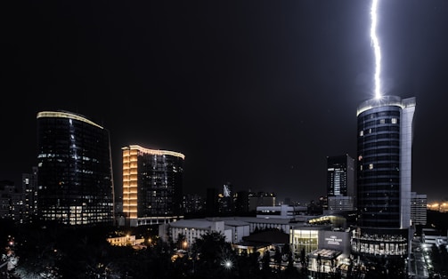 A cinematic still showing a dramatic urban nightscape with vivid lighting effects.