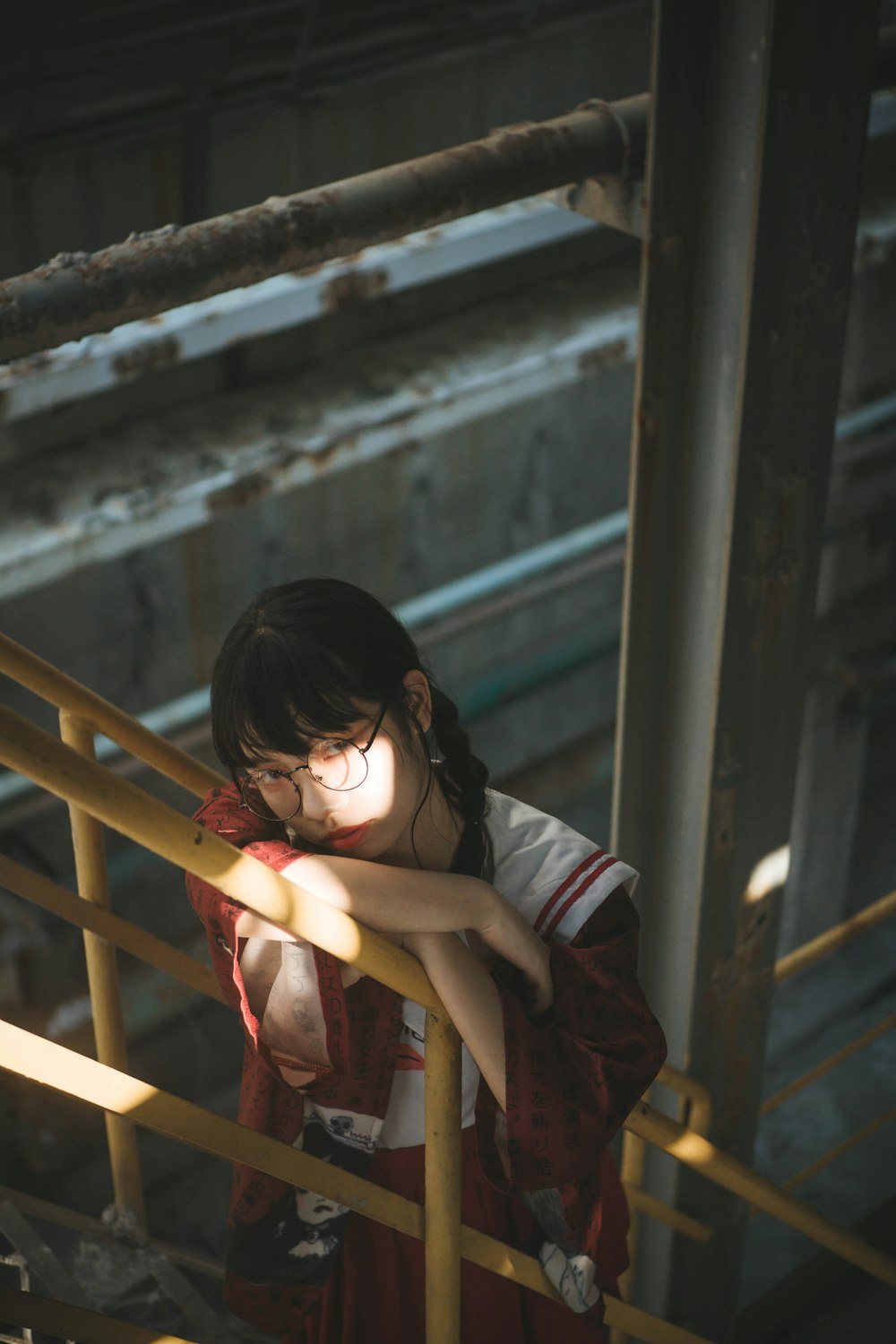 woman holding yellow stair rail