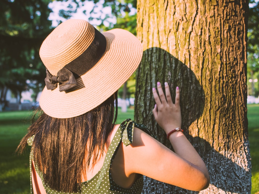 woman holding brown tree trunk