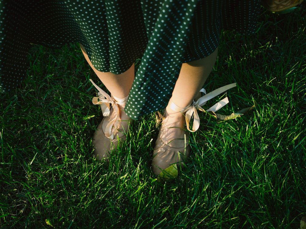 person wearing pair of brown ballerina flats