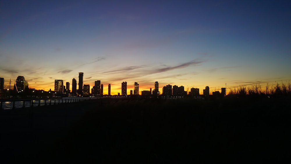 a view of a city skyline at sunset