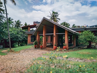 a brick house with potted plants in front of it