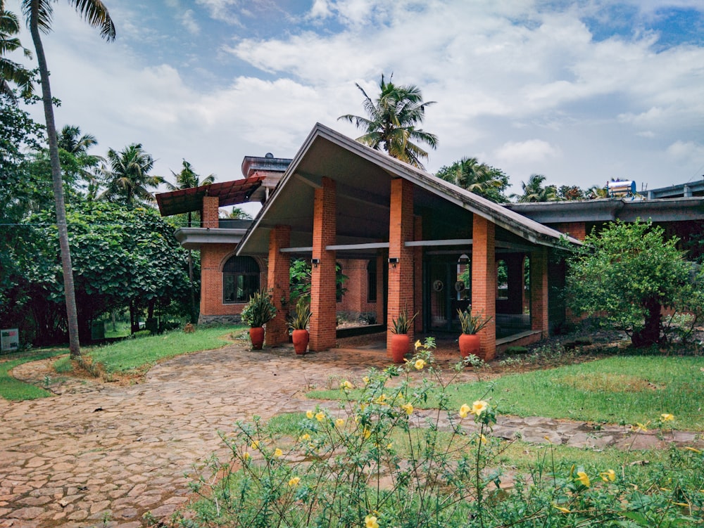 a brick house with potted plants in front of it