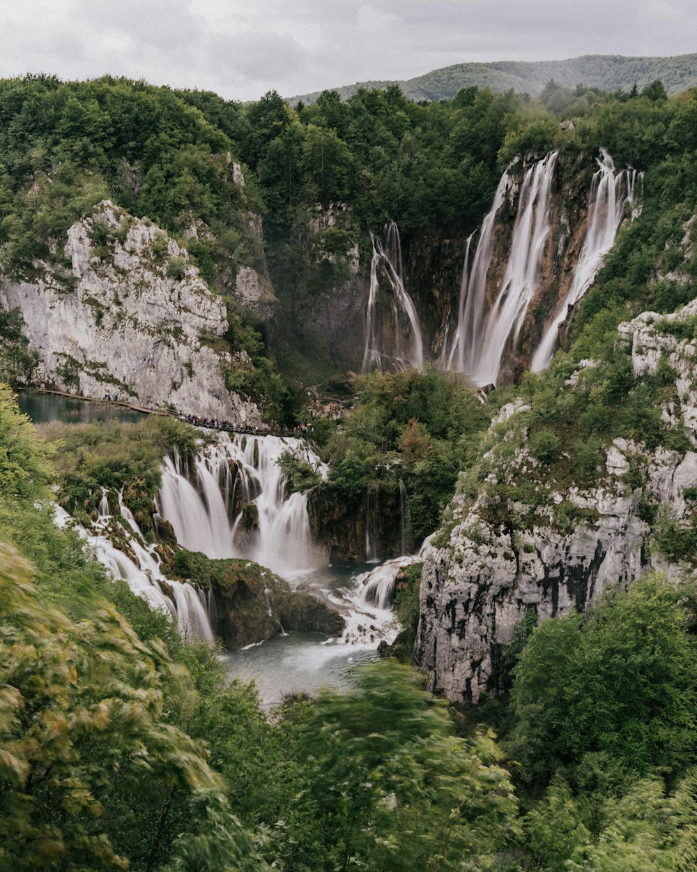 waterfalls and green trees photo during daytime