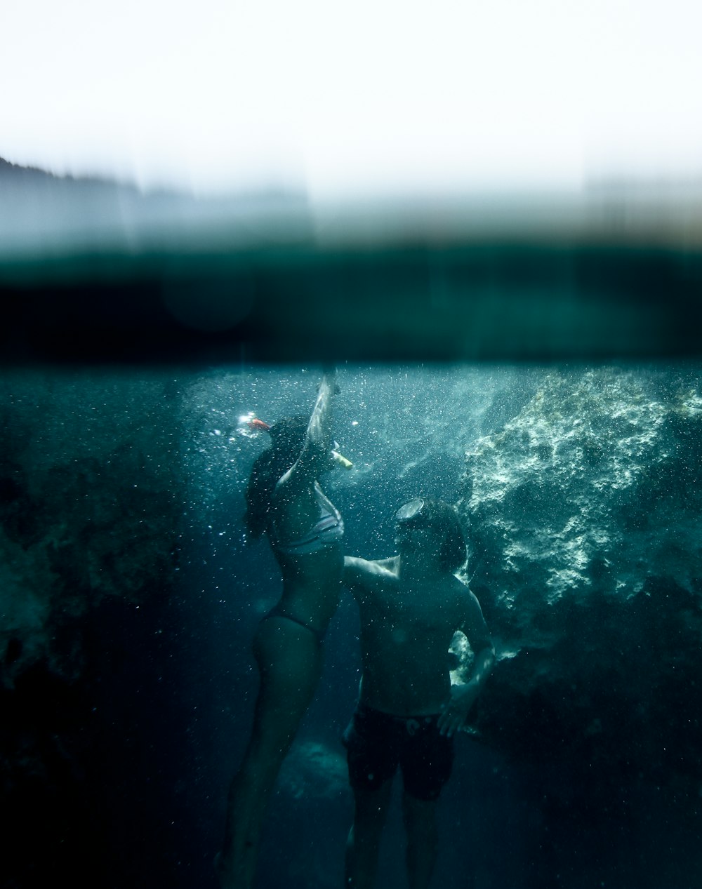 woman and man snorkeling under water