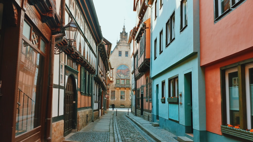 a narrow cobblestone street in a european city