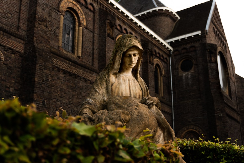 woman sitting on statue