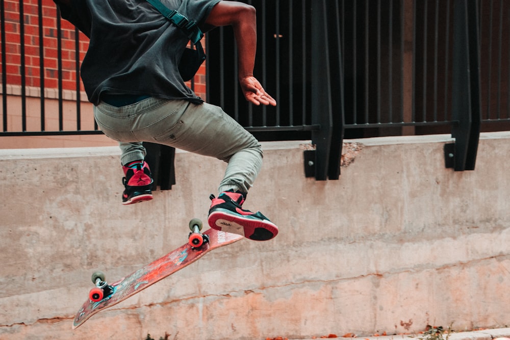 person skateboarding near fence