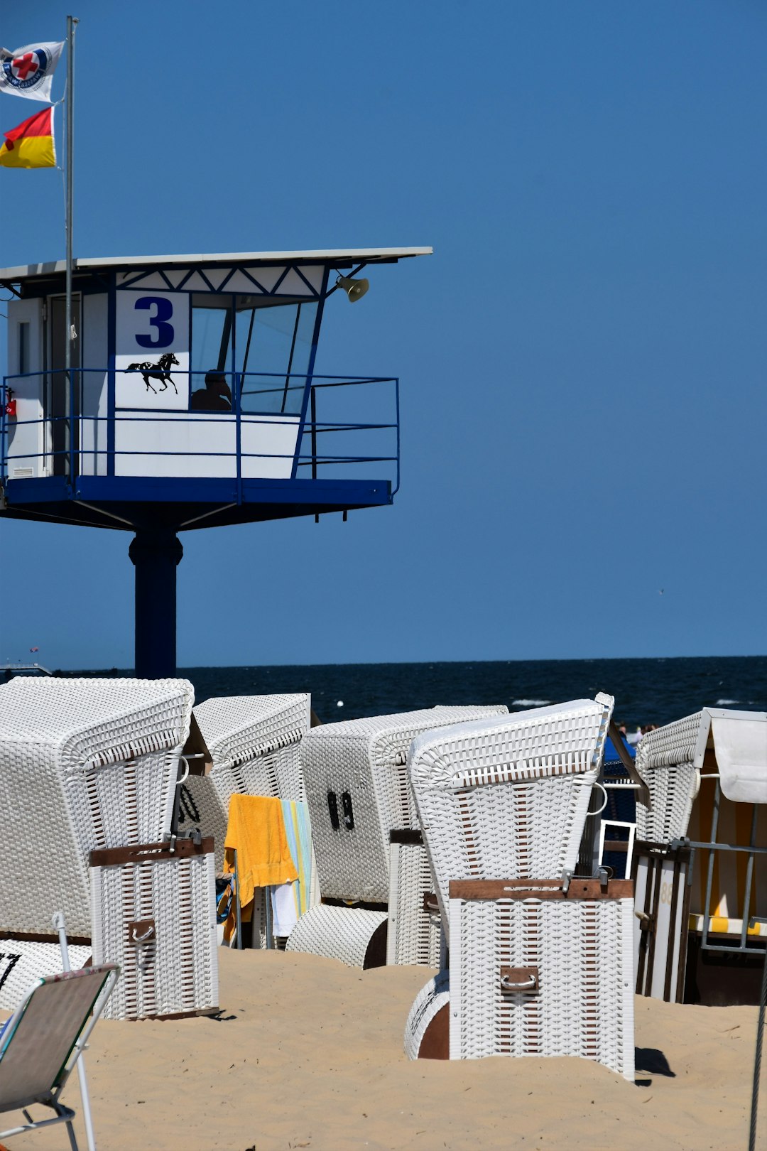 person in lifeguard tower at the beach during day