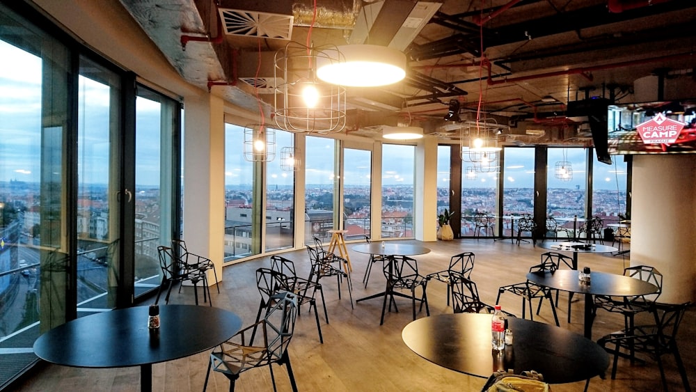 round black pedestal tables and black chairs