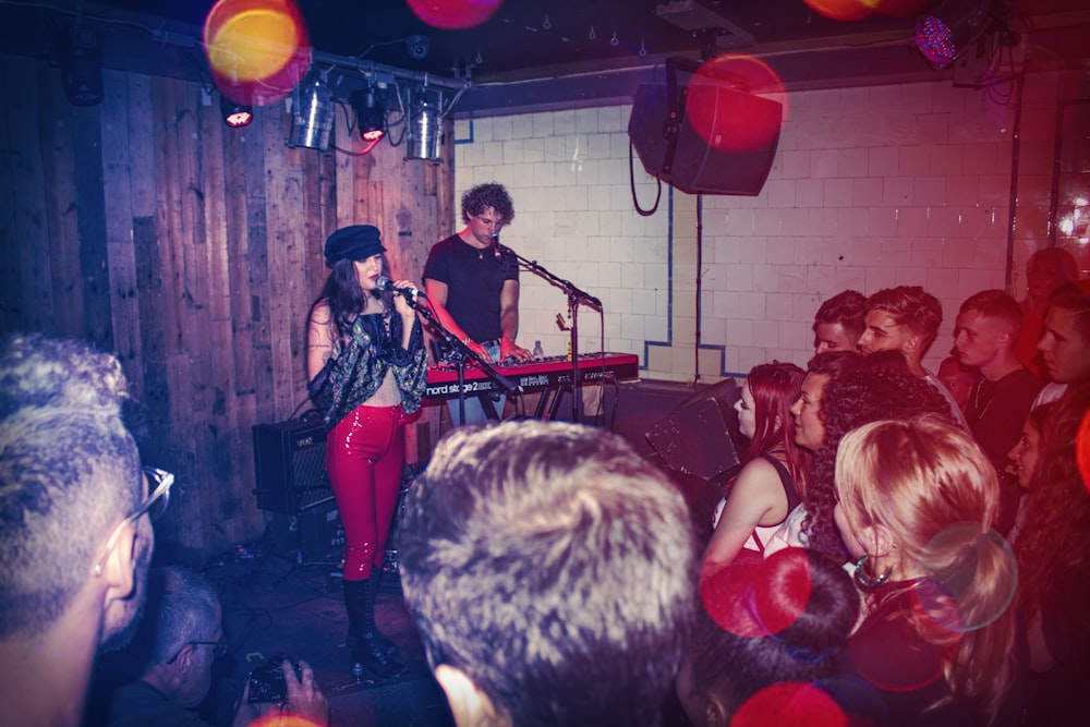 woman singing and man playing piano