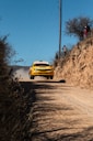 yellow rally car on road