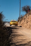 yellow rally car on road