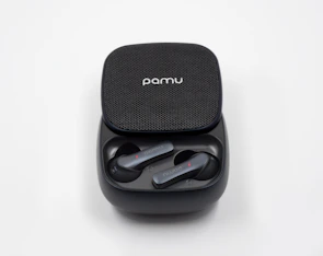 Modern wireless earbuds resting inside their compact charging case