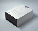 A sleek, modern black and gold branded box featuring the alpha bud club logo on a deep green background.