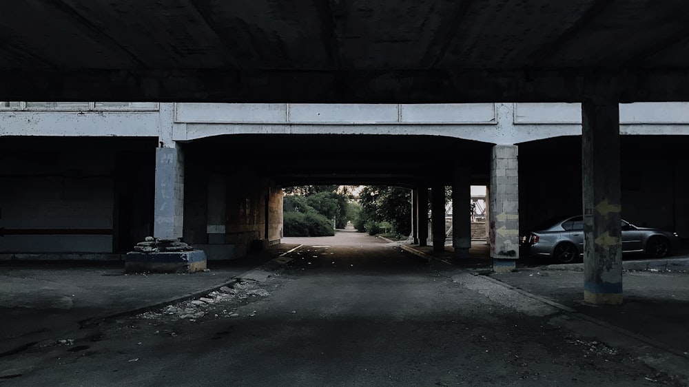 an empty parking garage with a car parked in it