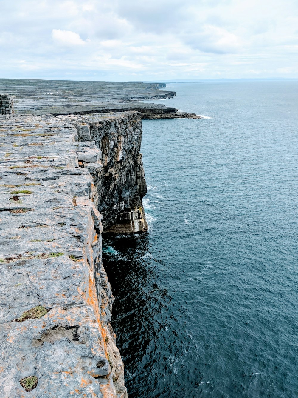 rocky cliff facing ocean