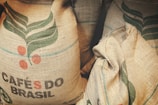 two bags of coffee beans sitting next to each other