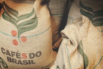 two bags of coffee beans sitting next to each other