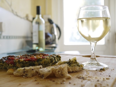 A beautifully plated tarte flambée paired with a glass of Alsatian white wine.