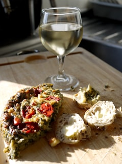 A beautifully arranged plate of local appetizers paired with a glass of white wine.