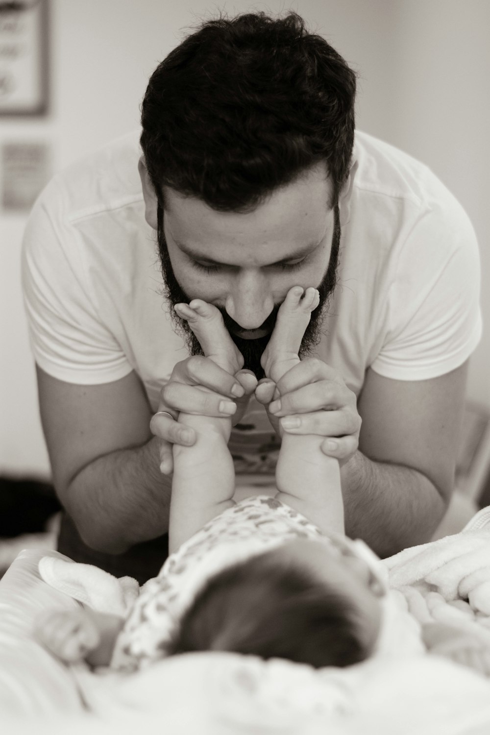 grayscale photography of man playing with baby