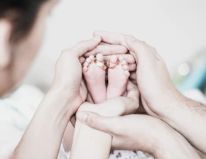 couple holding baby's feet
