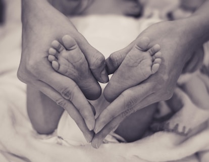 person holding's baby's feet