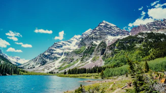 green, white, and gray mountains under blue sky