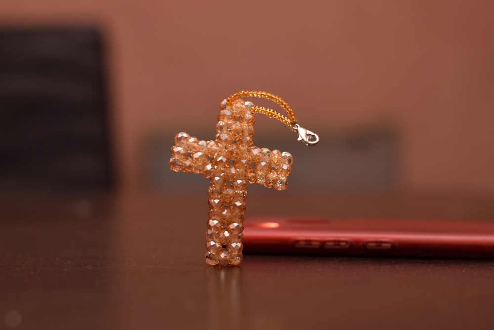 gold-colored cross with white pearls macro photography