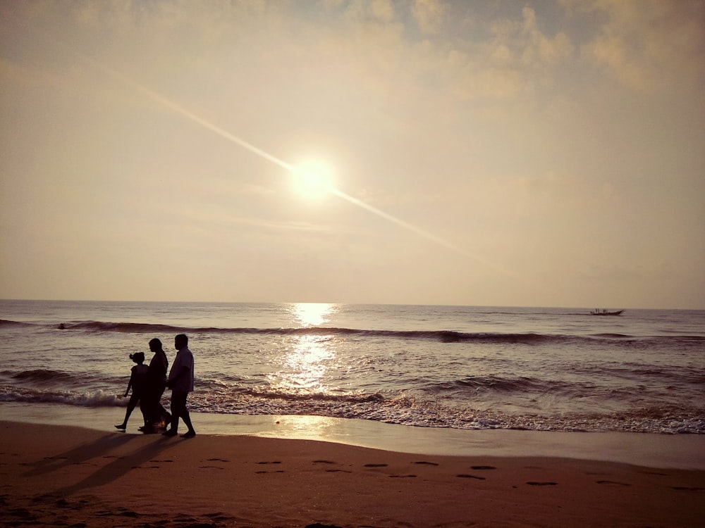 three people in seashore