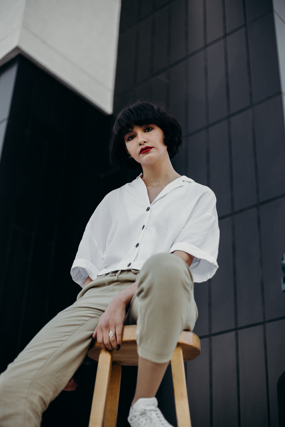 woman sitting on brown stool