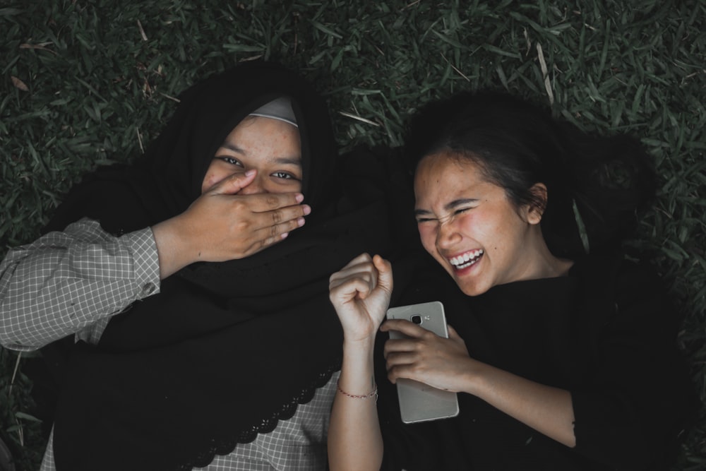 smiling women lying on ground