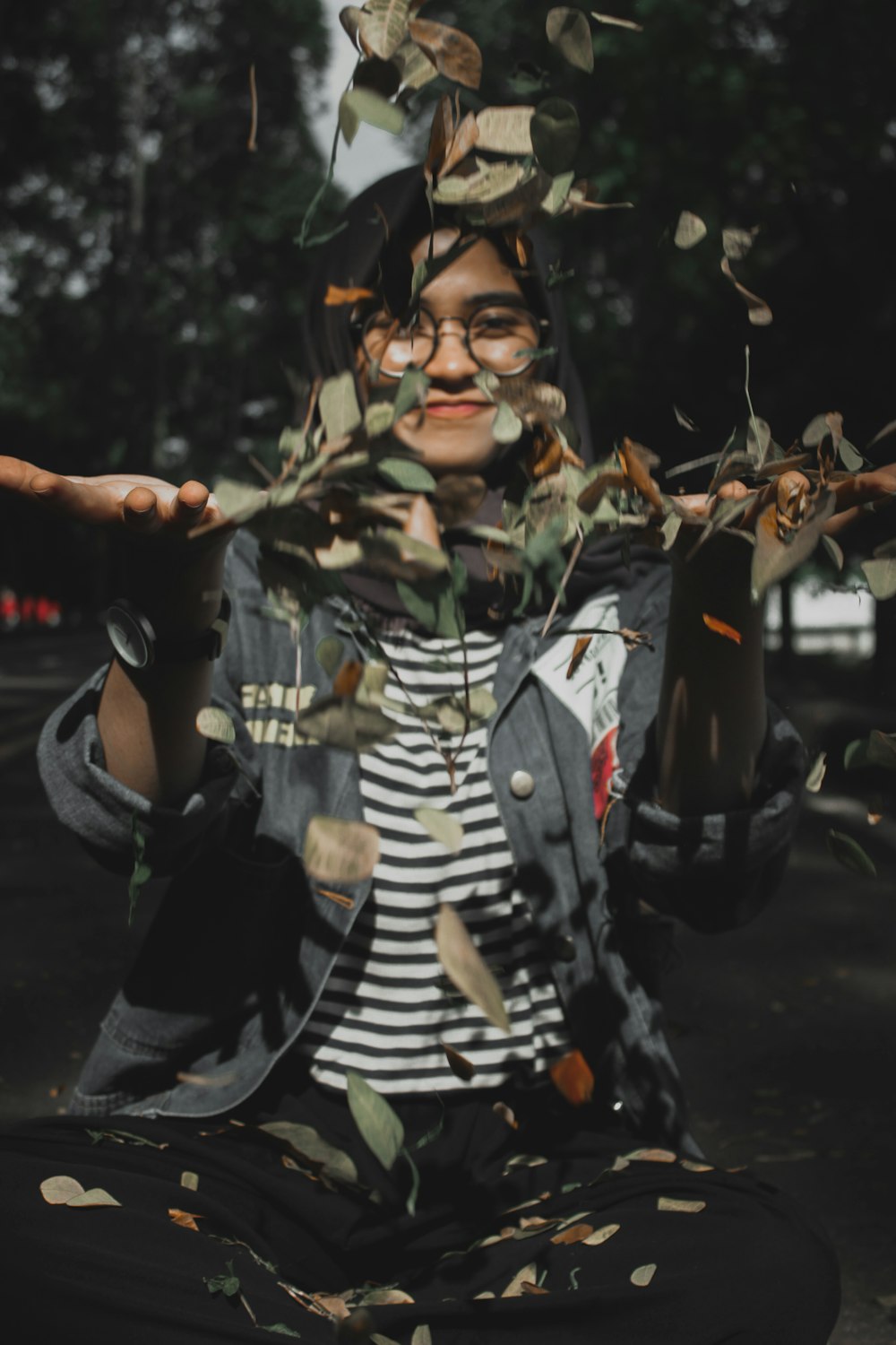 woman in gray vest with leaves