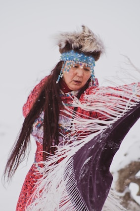 woman wearing red dress holding purple and white scarf