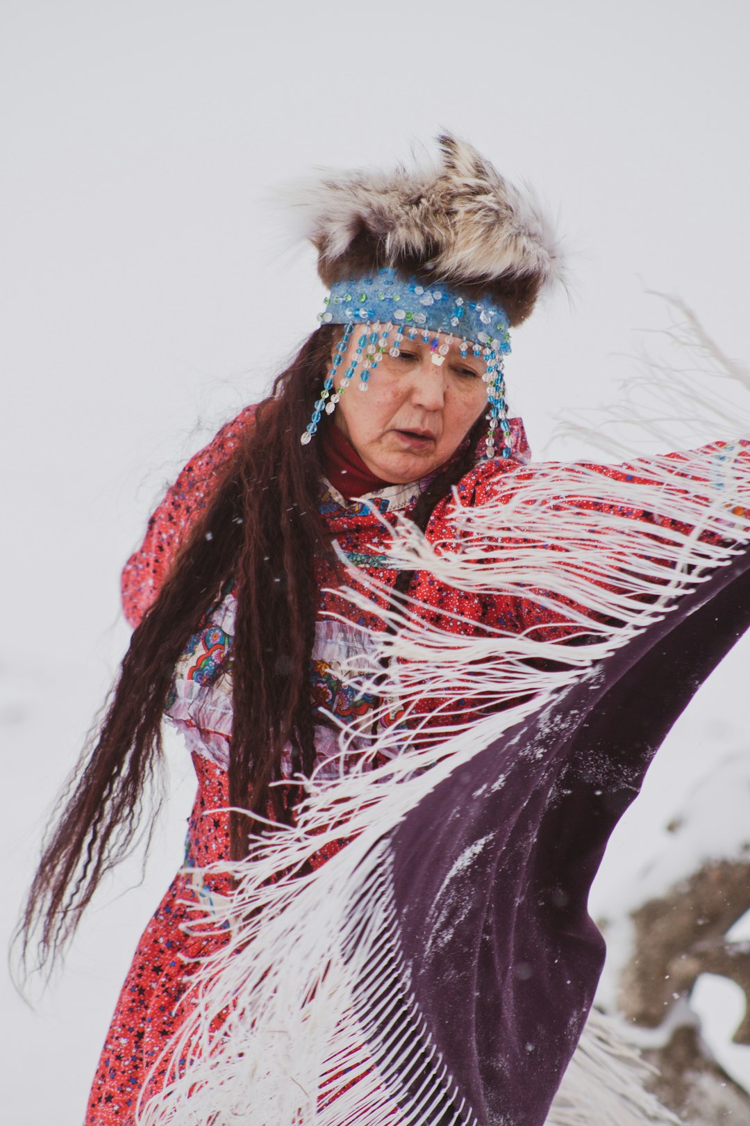 woman wearing red dress holding purple and white scarf