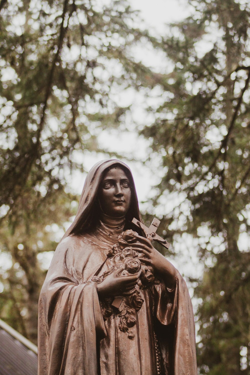 woman holding flower statue