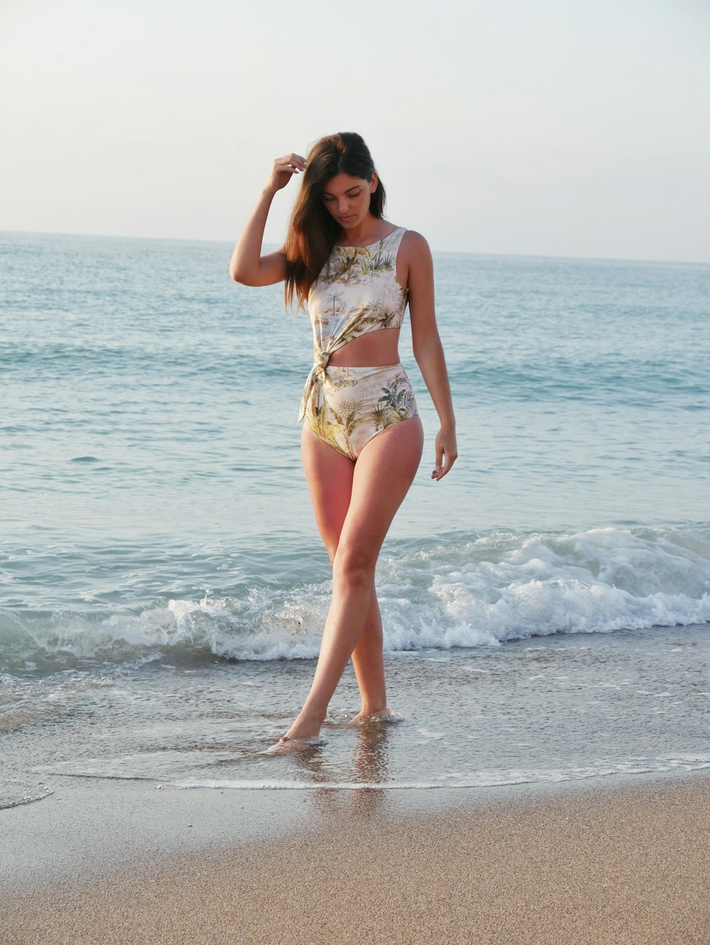 woman in bikini standing in seashore