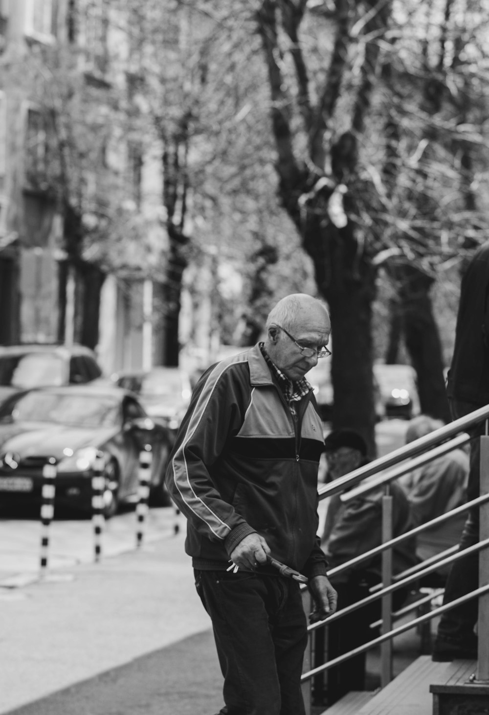 grayscale photography of man near stairs