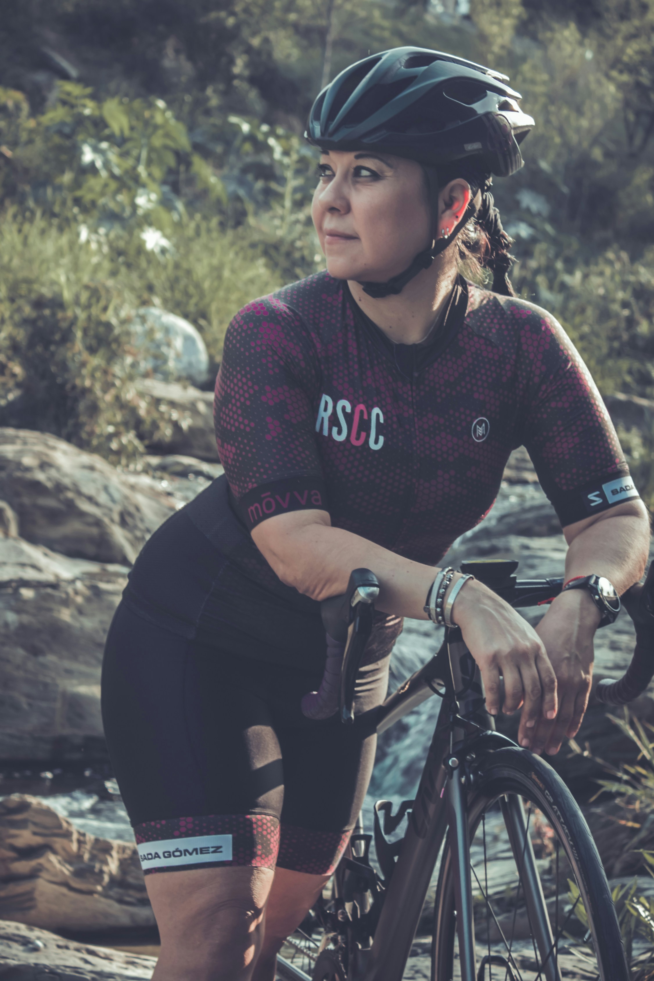 A woman looking at her reflection in water under a moonlit sky, contemplating feelings of sadness during her menstrual cycle.