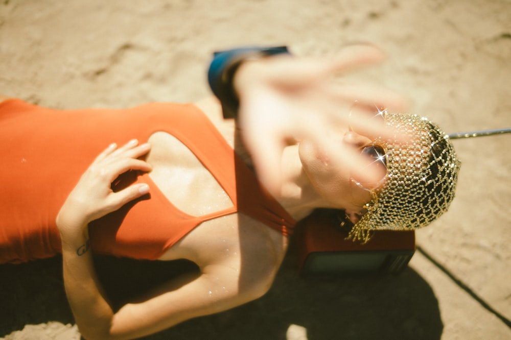 woman in orange dress lying on ground