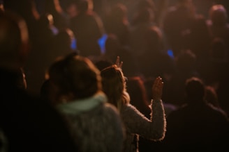 a crowd of people standing in a dark room