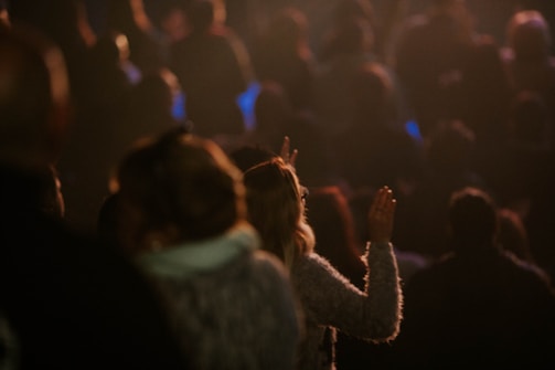 a crowd of people standing in a dark room