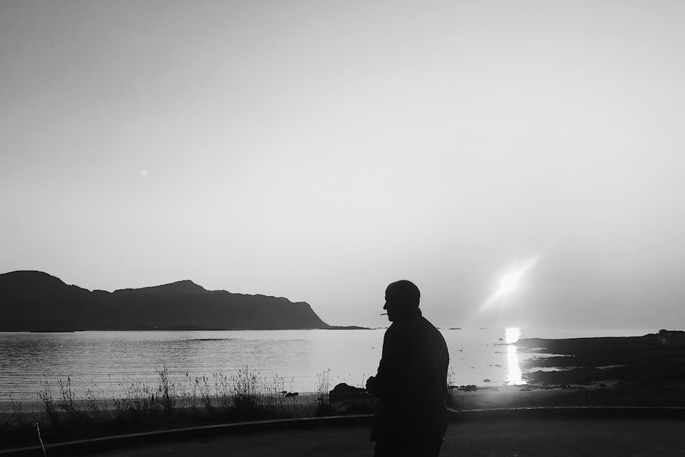 silhouette of person near body of water