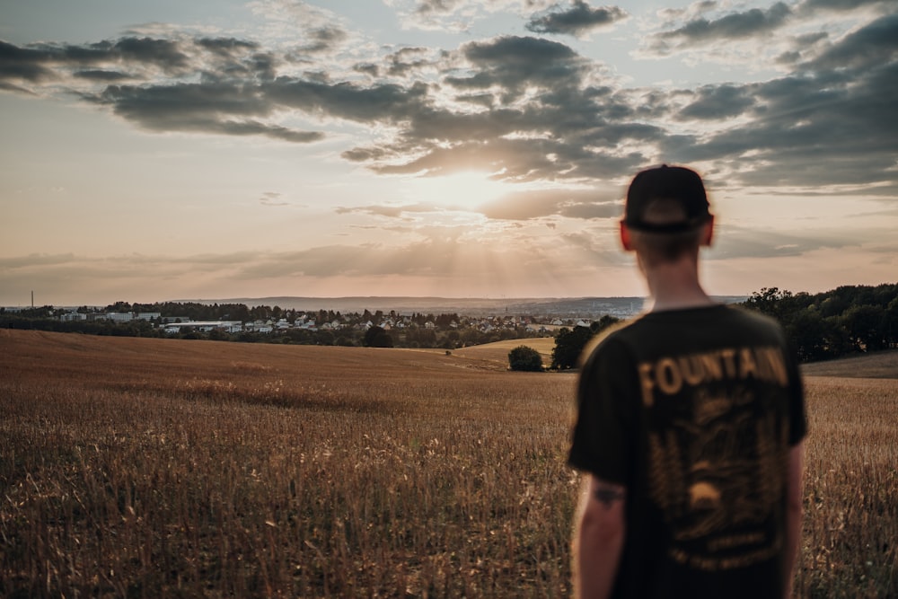 man standing near whey field