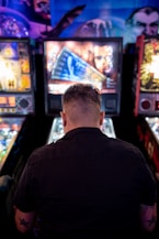 man playing arcade machine