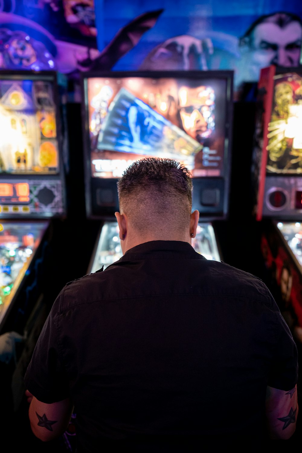 man playing arcade machine
