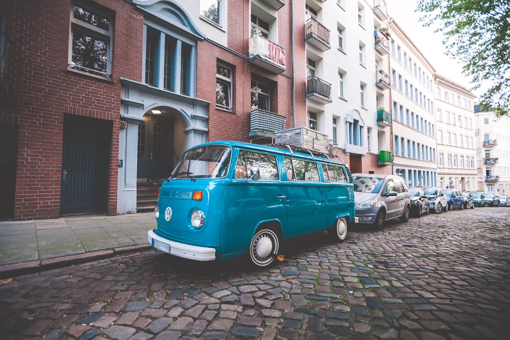 blue van beside paved road