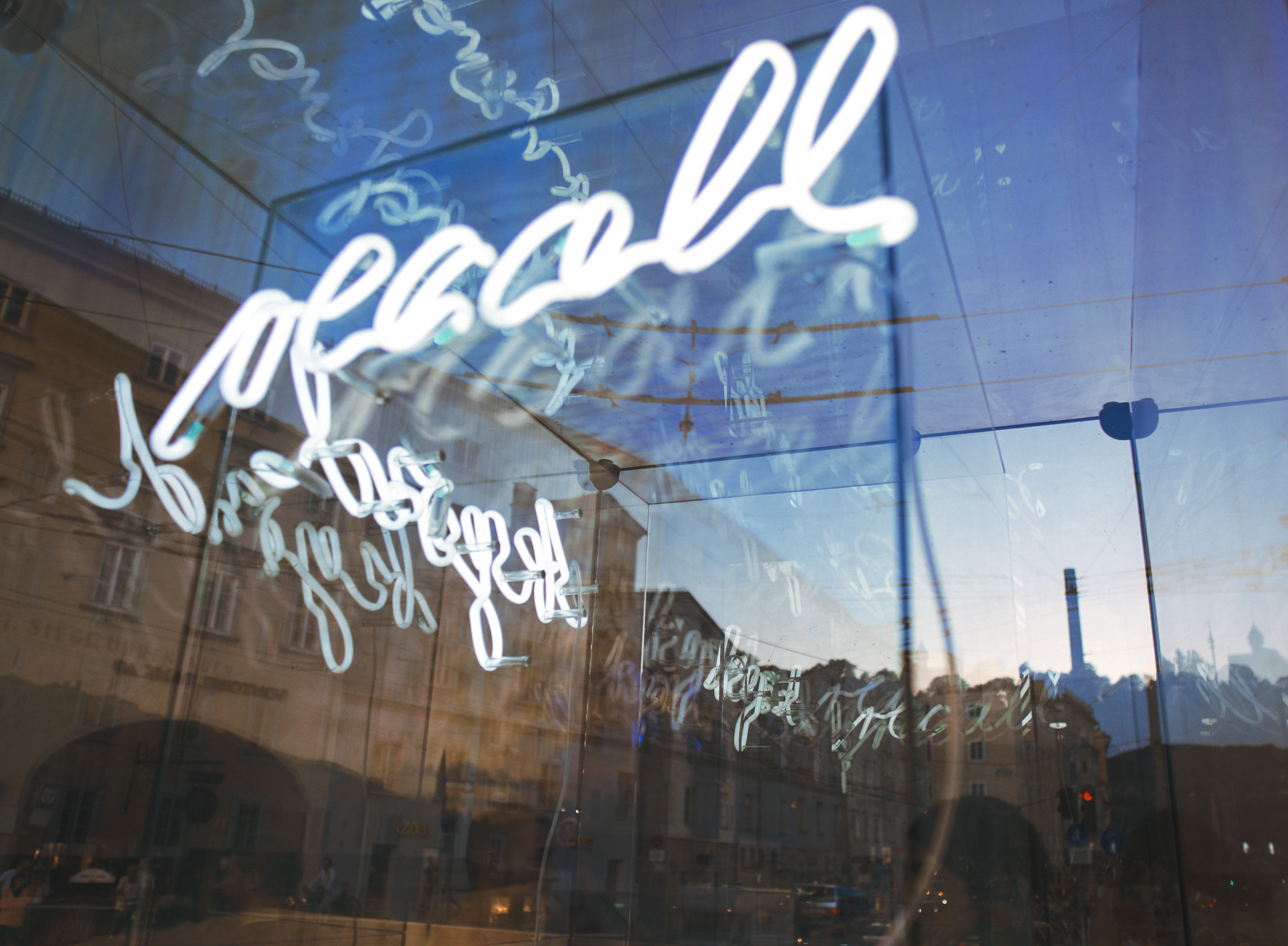 the reflection of a building in a glass window