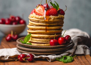 person pouring syrup on pancake